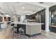 Open kitchen featuring a large island with seating, stainless steel appliances, and dark cabinetry in a well-lit interior at 200 Skiff Pt # 202, Clearwater Beach, FL 33767
