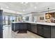 Kitchen island features white countertop, stainless steel dishwasher, and modern faucet at 200 Skiff Pt # 202, Clearwater Beach, FL 33767
