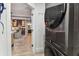 A front loading washer and dryer are framed by a glimpse of a dining space beyond an open doorway at 200 Skiff Pt # 202, Clearwater Beach, FL 33767