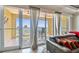 Bright living room featuring a balcony with waterfront views and comfortable seating with views at 200 Skiff Pt # 202, Clearwater Beach, FL 33767