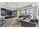Spacious living room with water views, gray sofa, and modern entertainment center at 200 Skiff Pt # 202, Clearwater Beach, FL 33767