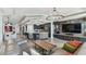 Open-concept living space with modern kitchen, bar seating, and luxury furnishings at 200 Skiff Pt # 202, Clearwater Beach, FL 33767