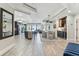 Wide view of an open-concept living space with kitchen, dining area, and living room under a continuous decorative ceiling at 200 Skiff Pt # 202, Clearwater Beach, FL 33767