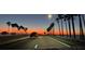Road with palm trees and a vehicle at sunset at 200 Skiff Pt # 202, Clearwater Beach, FL 33767