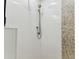 Elegant shower featuring a pebble accent wall and floor, plus sleek white tile at 200 Skiff Pt # 202, Clearwater Beach, FL 33767