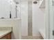 Elegant shower featuring a pebble accent wall and floor, plus a built in bench at 200 Skiff Pt # 202, Clearwater Beach, FL 33767