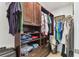 A spacious walk-in closet with custom shelves, drawers, and ample hanging space at 200 Skiff Pt # 202, Clearwater Beach, FL 33767