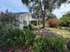 Lush backyard with mature landscaping, stone path, and screened patio at 20938 Sunsweet Ct, Land O Lakes, FL 34637