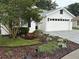 Charming home featuring a landscaped front yard with vibrant plantings and a brick driveway at 20938 Sunsweet Ct, Land O Lakes, FL 34637