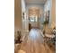 Inviting hallway with hardwood floors, arched doorway, and stylish decor at 20938 Sunsweet Ct, Land O Lakes, FL 34637