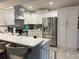 Bright kitchen featuring white cabinets, stainless steel appliances, and tiled backsplash at 20938 Sunsweet Ct, Land O Lakes, FL 34637