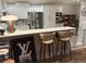Modern kitchen with white cabinetry, stainless steel appliances, and breakfast bar at 20938 Sunsweet Ct, Land O Lakes, FL 34637