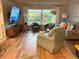 Bright living room with hardwood floors, large window, and stylish furnishings at 20938 Sunsweet Ct, Land O Lakes, FL 34637