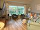 Inviting living room with hardwood floors, neutral decor, and large window at 20938 Sunsweet Ct, Land O Lakes, FL 34637