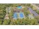 Aerial view of community amenities, including tennis courts, a playground, and a sparkling swimming pool at 2124 Rensselaer Dr, Wesley Chapel, FL 33543