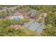 Aerial view of the community pool, clubhouse, playground, and basketball courts surrounded by mature trees at 2124 Rensselaer Dr, Wesley Chapel, FL 33543