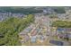 An aerial view of a neighborhood with well-maintained homes, lush landscaping, and multiple ponds at 2124 Rensselaer Dr, Wesley Chapel, FL 33543
