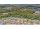 An aerial view of the neighborhood highlighting the lush greenery, pond and convenient location at 2124 Rensselaer Dr, Wesley Chapel, FL 33543