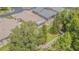 Aerial view of a large, well-maintained backyard with a screened-in patio and white vinyl fence at 2124 Rensselaer Dr, Wesley Chapel, FL 33543