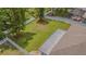 Aerial view of a spacious backyard with manicured lawn, privacy fence, and mature tree coverage at 2124 Rensselaer Dr, Wesley Chapel, FL 33543