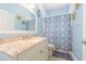 This bathroom features blue walls, a granite countertop, and a vanity at 2124 Rensselaer Dr, Wesley Chapel, FL 33543