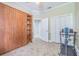 Neutral bedroom with a Murphy bed, storage shelves, and a ceiling fan at 2124 Rensselaer Dr, Wesley Chapel, FL 33543