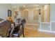 Open-concept dining room featuring wood floors, decorative archways, and elegant furnishings at 2124 Rensselaer Dr, Wesley Chapel, FL 33543
