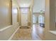 Welcoming entryway with tiled floors, front door with transom window, and views into the dining room at 2124 Rensselaer Dr, Wesley Chapel, FL 33543