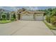 Attractive single-Gathering home with well-kept lawn, mature shrubbery, and an attached three-car garage at 2124 Rensselaer Dr, Wesley Chapel, FL 33543