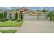 Beautiful home featuring manicured lawn, lush landscaping, and an attached three-car garage for ample parking at 2124 Rensselaer Dr, Wesley Chapel, FL 33543