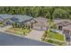 Charming single-Gathering home with an attached three-car garage, a landscaped front yard, and mature trees at 2124 Rensselaer Dr, Wesley Chapel, FL 33543