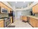 Spacious kitchen with stainless steel appliances, granite countertops, and wooden cabinets at 2124 Rensselaer Dr, Wesley Chapel, FL 33543