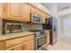 Modern kitchen features stainless steel appliances, granite countertops, and wooden cabinets at 2124 Rensselaer Dr, Wesley Chapel, FL 33543