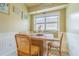 Bright eat-in kitchen area with natural light and cozy seating with chair and bench at 2124 Rensselaer Dr, Wesley Chapel, FL 33543