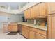 Close-up of spacious kitchen with stainless steel appliances, granite countertops, and wooden cabinets at 2124 Rensselaer Dr, Wesley Chapel, FL 33543