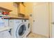 Bright laundry room featuring modern washer and dryer, storage cabinets, and granite countertops at 2124 Rensselaer Dr, Wesley Chapel, FL 33543