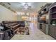 Stylish living room with tile flooring, open layout, entertainment center, and leather sectional at 2124 Rensselaer Dr, Wesley Chapel, FL 33543