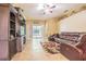 Inviting living room features tile floors, a large TV, entertainment center, and a comfortable leather sectional at 2124 Rensselaer Dr, Wesley Chapel, FL 33543