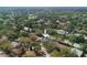 A high-angle aerial shot displays a serene neighborhood with tree-lined streets at 2318 Kenwick Dr, Valrico, FL 33596