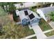 Birds eye view of a two-story home with solar panels and spacious driveway at 2318 Kenwick Dr, Valrico, FL 33596