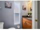 Well-lit bathroom with a granite countertop, wooden cabinets, and neutral decor at 2318 Kenwick Dr, Valrico, FL 33596