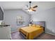 Bright bedroom with a large window, ceiling fan, and comfortable bed with padded headboard at 2318 Kenwick Dr, Valrico, FL 33596