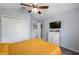 Cozy bedroom with a ceiling fan, closet, and dresser with TV for relaxed, comfortable living at 2318 Kenwick Dr, Valrico, FL 33596