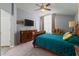 Elegant bedroom with a wooden bed frame, ceiling fan, and dresser for relaxed living at 2318 Kenwick Dr, Valrico, FL 33596