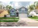 Charming two-story home with a well-maintained lawn and an attached two-car garage at 2318 Kenwick Dr, Valrico, FL 33596
