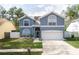Charming two-story home with a well-maintained lawn and an attached two-car garage at 2318 Kenwick Dr, Valrico, FL 33596