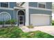 Welcoming front entrance showcasing an arched doorway and a two-car garage at 2318 Kenwick Dr, Valrico, FL 33596