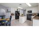 Well-equipped kitchen with granite countertops, white cabinets, an island, and stainless steel appliances at 2318 Kenwick Dr, Valrico, FL 33596