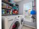 Functional laundry room with shelving, front-loading washer and dryer, and a window for natural light at 2318 Kenwick Dr, Valrico, FL 33596