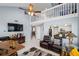 Spacious living room with a high ceiling, ceiling fan, leather furniture, and a view to the kitchen at 2318 Kenwick Dr, Valrico, FL 33596